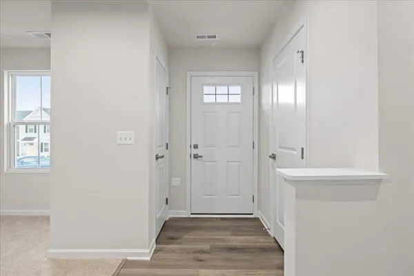 a large white kitchen with a stove top oven a sink and dishwasher