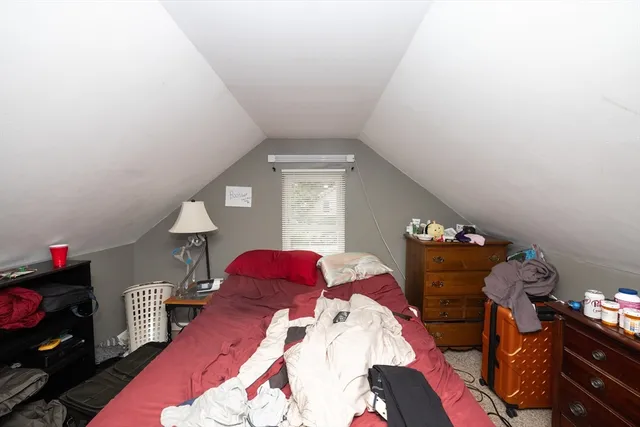 a bedroom with two bed and a window