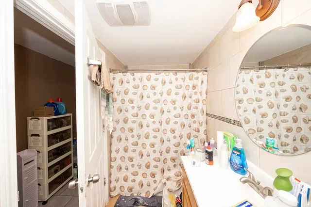 a bathroom with a shower curtain and a curtain