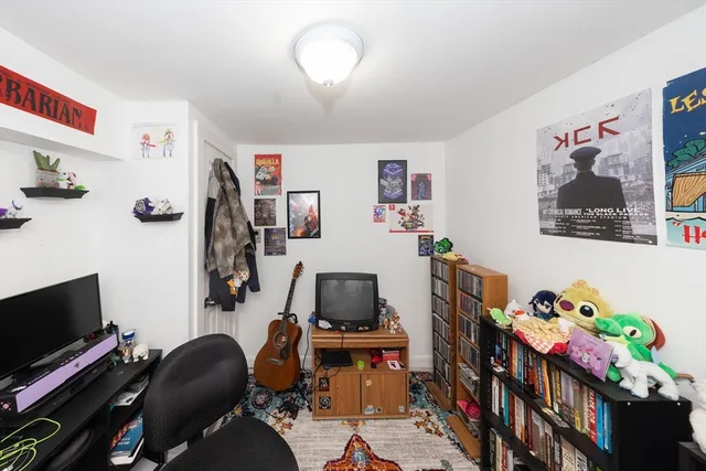 a storage room with wooden floor and cabinets
