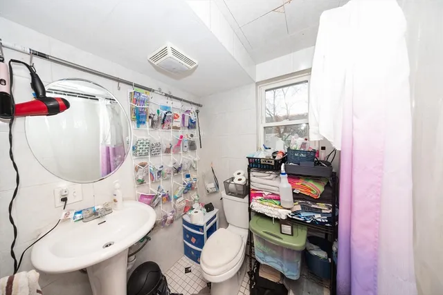 a bathroom with a sink toilet mirror and vanity