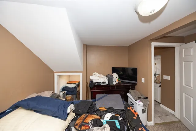 a bedroom with a bed and gym equipment