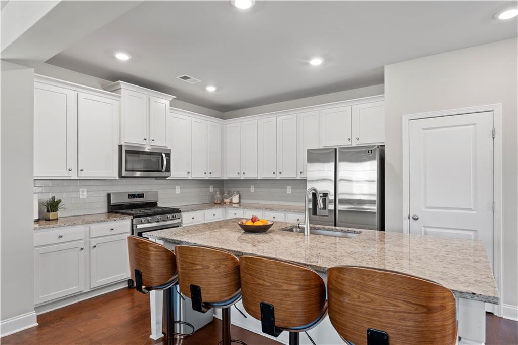 1030 Shy Lane Marietta, GA 30060 - Photo 14 of 50 a kitchen with stainless steel appliances granite countertop a refrigerator sink and cabinets