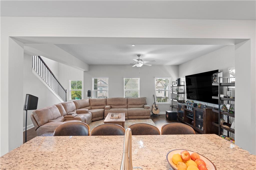 1030 Shy Lane Marietta, GA 30060 - Photo 15 of 50 a living room with furniture kitchen view and a flat screen tv
