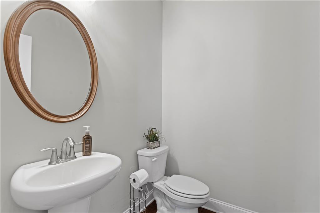 1030 Shy Lane Marietta, GA 30060 - Photo 18 of 50 a bathroom with a sink a mirror and a toilet