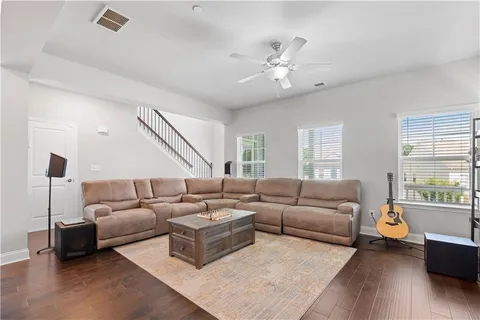 a living room with furniture and wooden floor