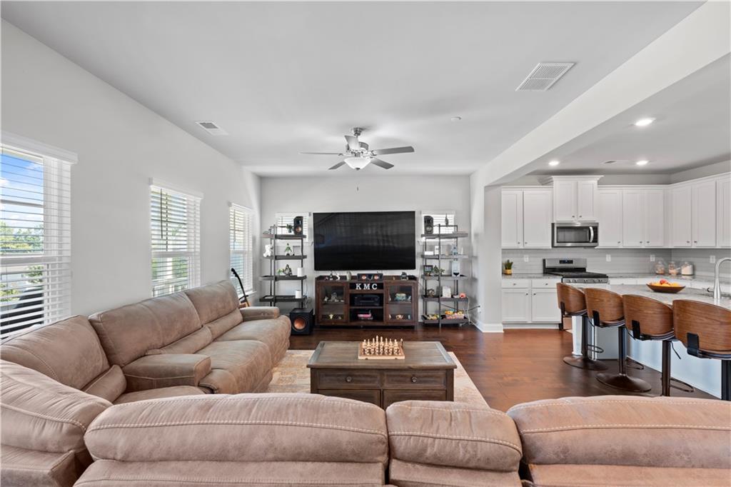 1030 Shy Lane Marietta, GA 30060 - Photo 21 of 50 a living room with furniture kitchen view and a flat screen tv