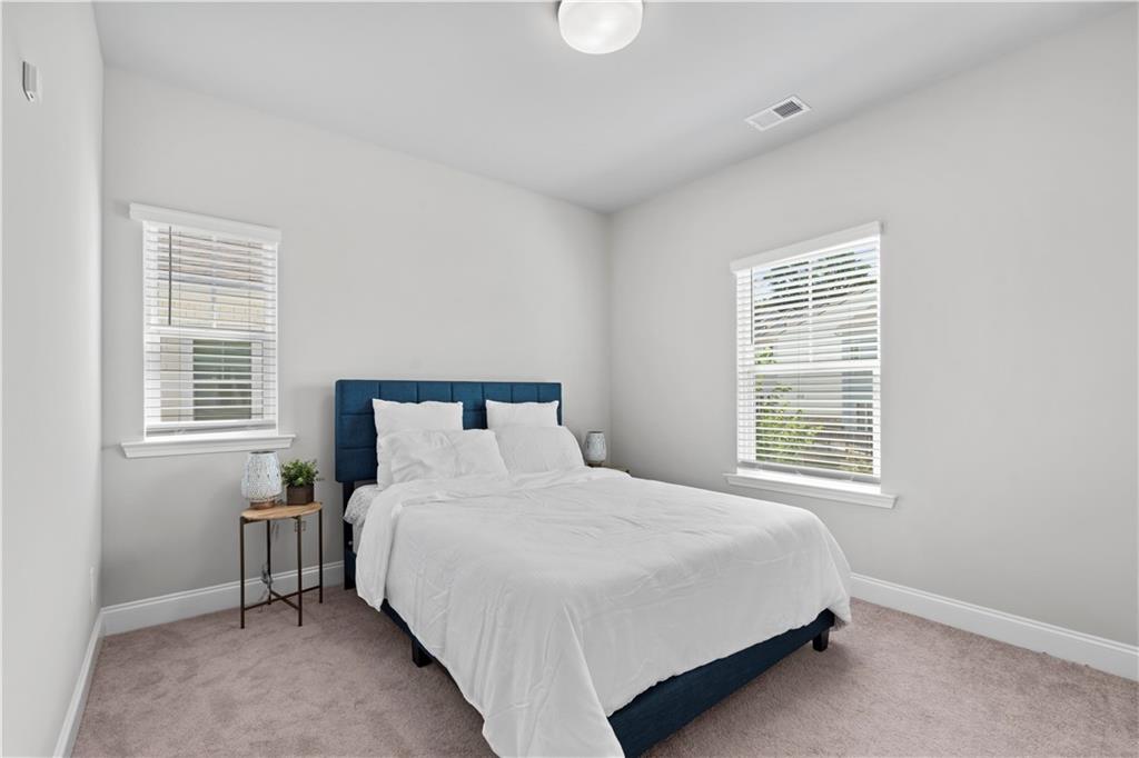 1030 Shy Lane Marietta, GA 30060 - Photo 34 of 50 a bedroom with a bed table and a window