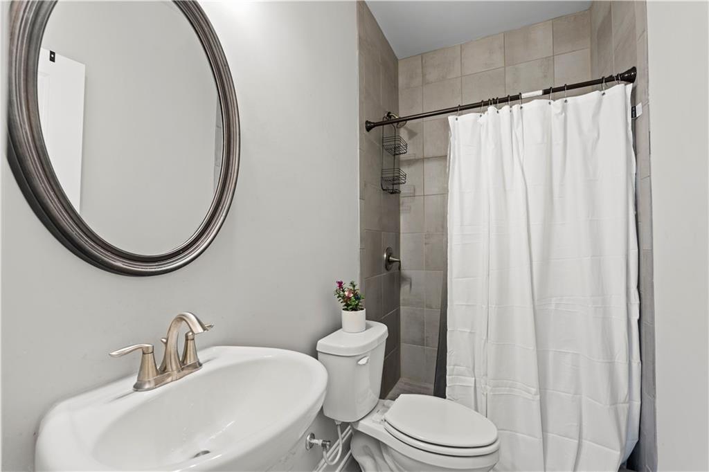1030 Shy Lane Marietta, GA 30060 - Photo 43 of 50 a bathroom with a sink and a mirror