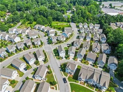 an aerial view of residential houses with outdoor space