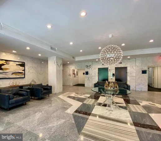 a living room with furniture a chandelier and a pool table