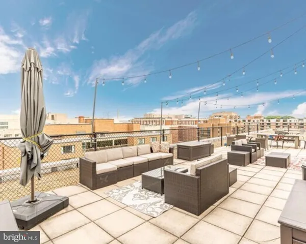 a living room with patio furniture and a fireplace