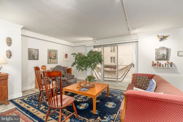 a living room with furniture a table and a large window