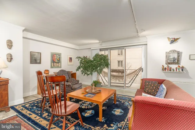 a living room with furniture a table and a large window