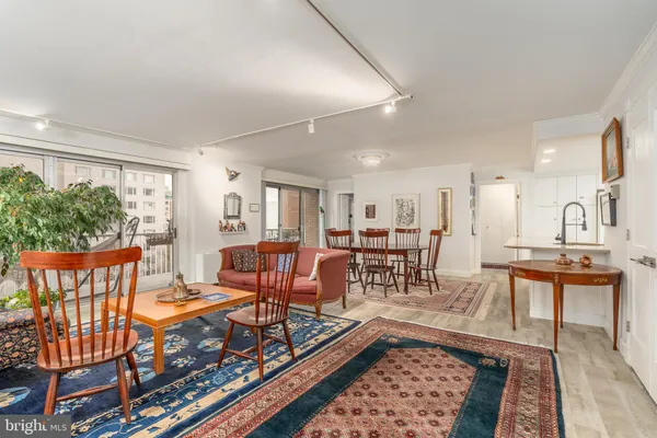 a living room with furniture a rug and a window