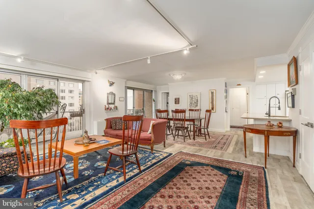 a living room with furniture a rug and a window
