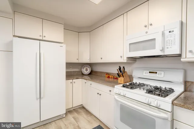 a kitchen with stainless steel appliances white cabinets and a stove