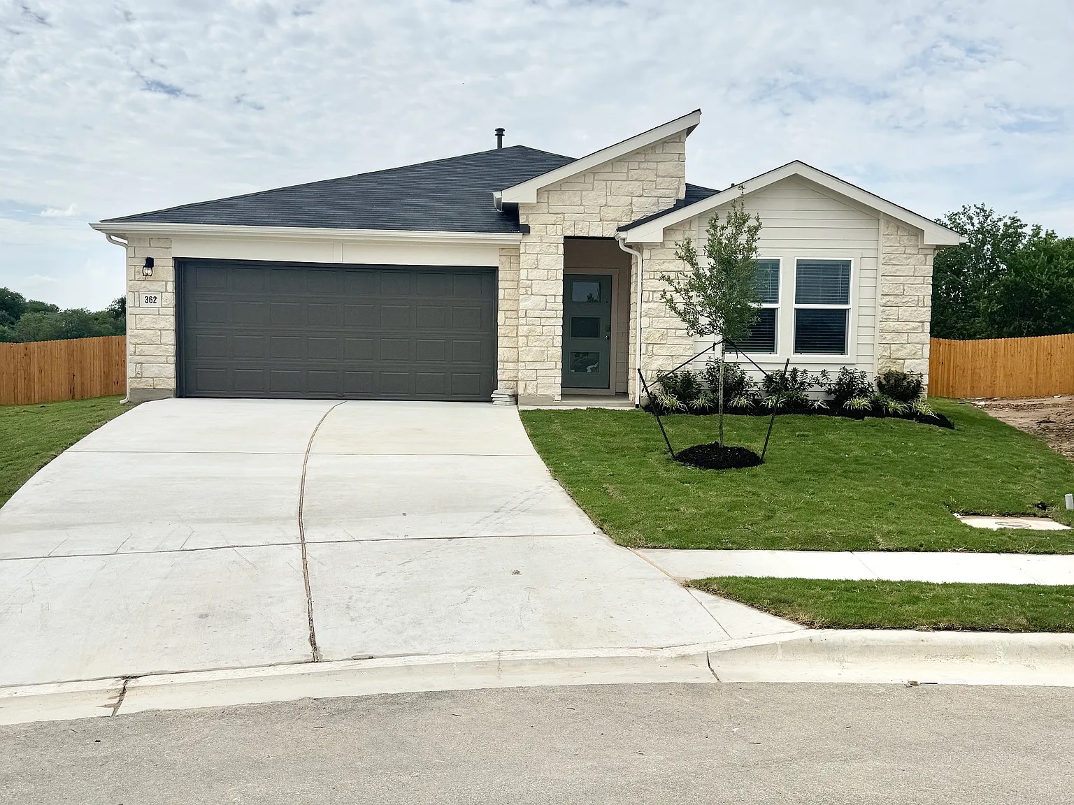 Contemporary single-story residence featuring a stone and siding exterior
