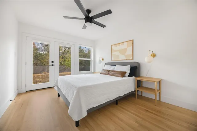 a large bed sitting in a bedroom next to a window