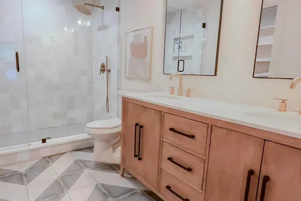 a bathroom with a sink a toilet and shower