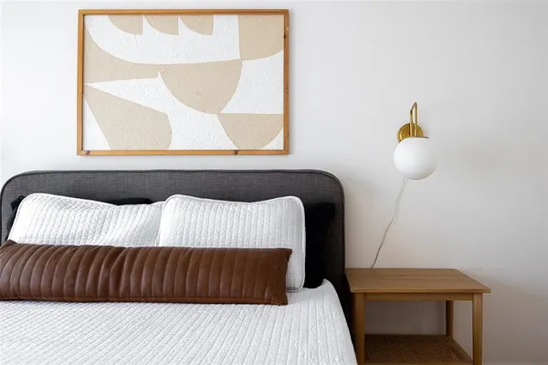 a bedroom with a bed and window