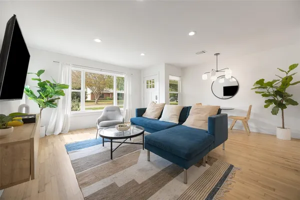 a living room with furniture potted plant and a window
