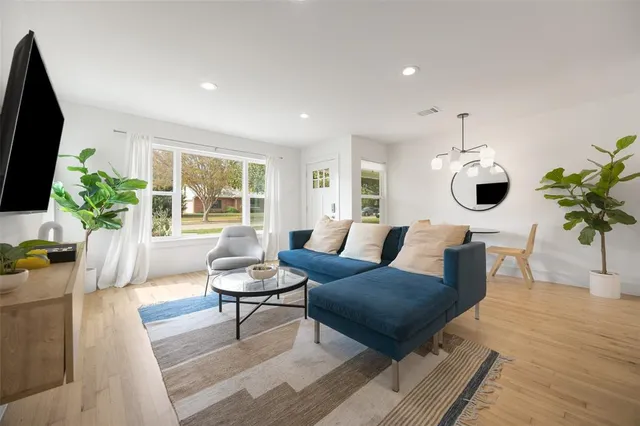 a living room with furniture potted plant and a window