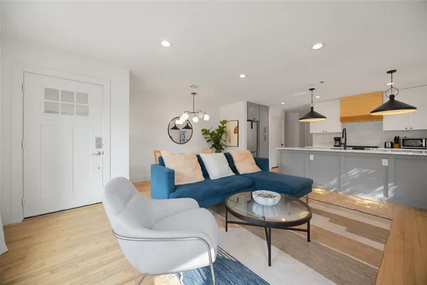 a living room with furniture and a wooden floor