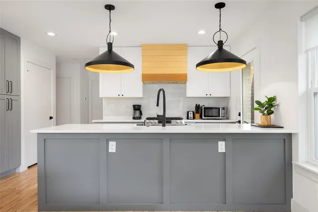 a kitchen with stainless steel appliances a sink a stove and a window