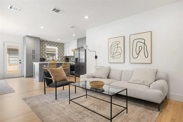 a living room with furniture and kitchen view