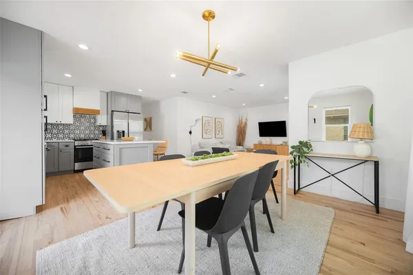 a large kitchen with a table and chairs