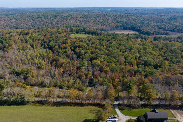 an aerial view of a houses with a yard