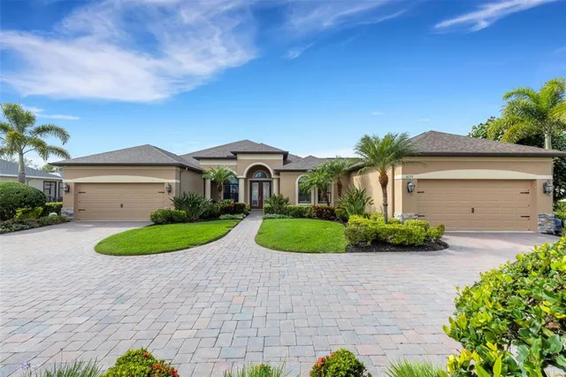 a kitchen with granite countertop a stove a sink a dining table and chairs