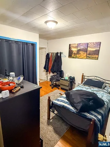 a bedroom with bed and a walk in closet