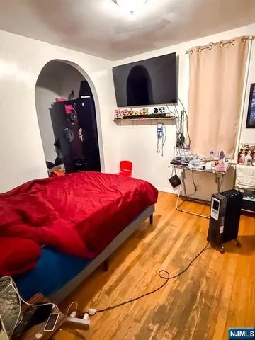 a bed room with a bed and a television