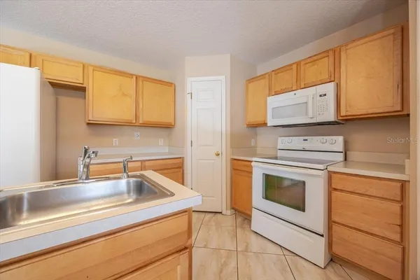a kitchen with a sink stove and microwave