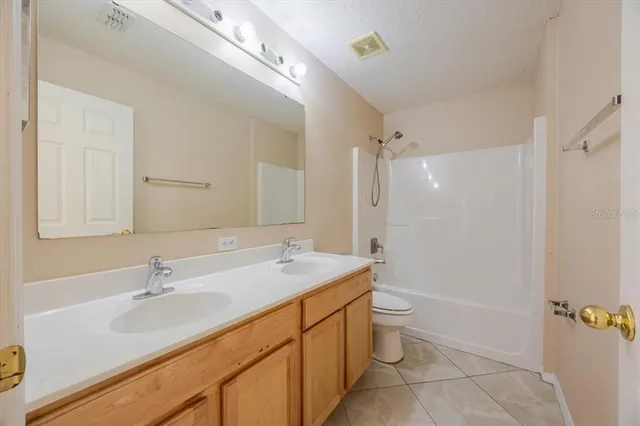 a bathroom with a sink a toilet a shower and a mirror