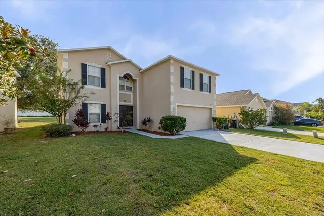 a view of a house with a yard and sitting area