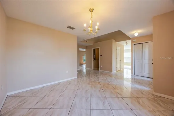 a view of an empty room with a chandelier
