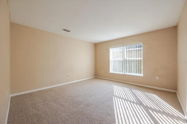 a view of an empty room with a window