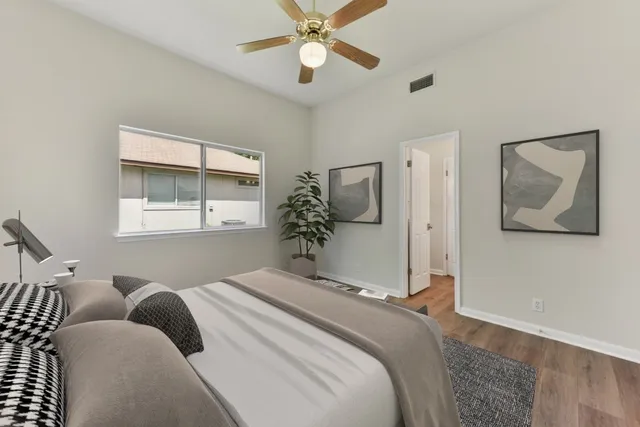 a bedroom with a large bed and a window