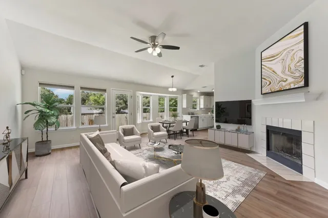 a living room with furniture a fireplace and a flat screen tv