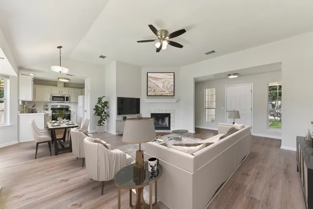 a living room with stainless steel appliances kitchen island furniture and a chandelier