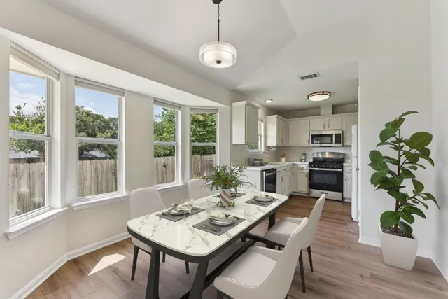 a view of a dining room with furniture window and wooden floor
