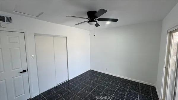 a view of a room with wooden floor and white walls