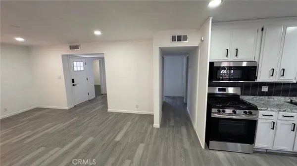 a kitchen with a stove and a refrigerator