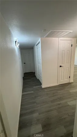 a view of a hallway with wooden floor
