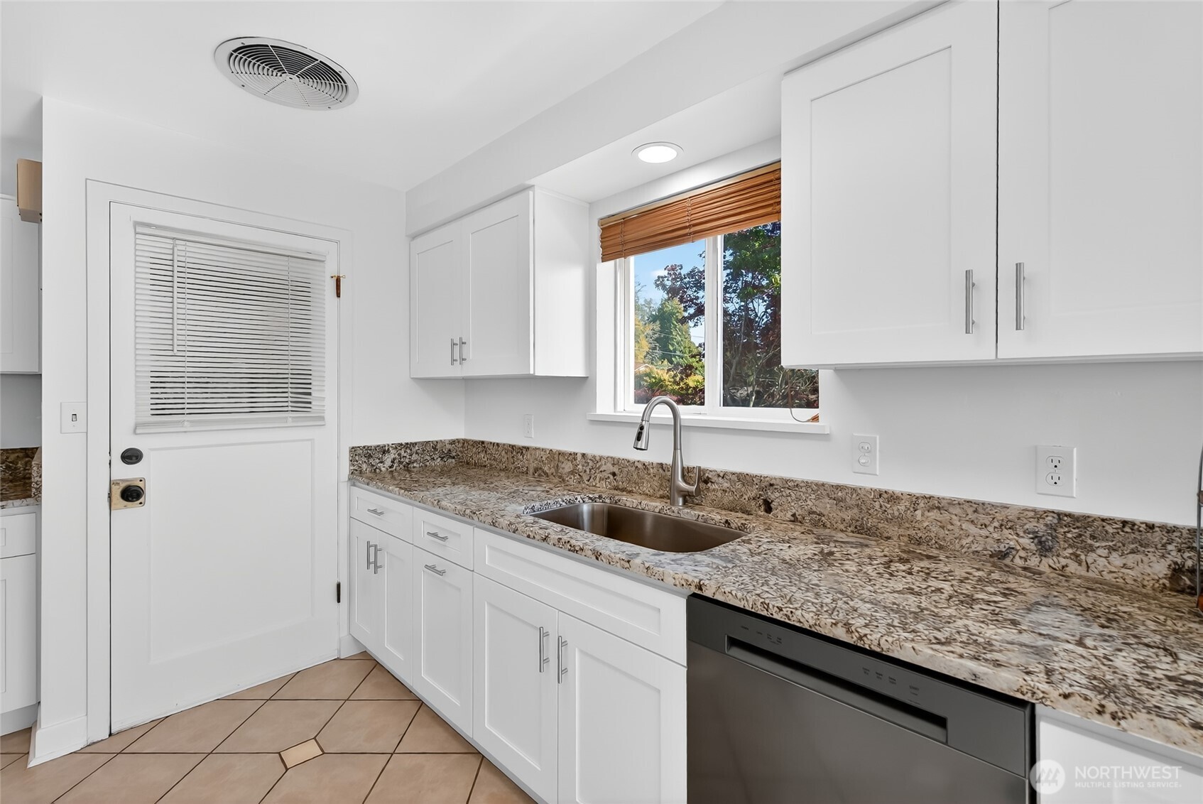 2493 Hilltop Road Ferndale, WA 98248 - Photo 10 of 35 a kitchen with granite countertop a sink window and cabinets