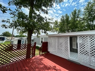 1600 Riverdale Road, Unit 75 Rock Falls, IL 61071 - Photo 4 of 17 a view of a porch area with wooden fence