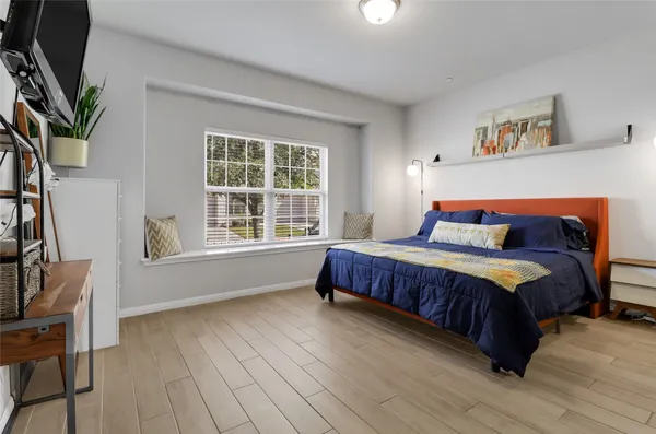 a bedroom with a large bed and a window